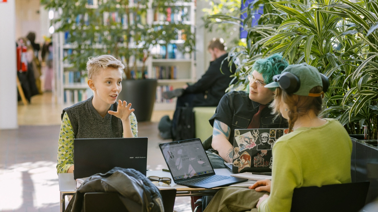 Students in conversation in a cosy study space.
